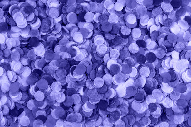 istock Festive purple confetti background. Flat lay style. 1358184318