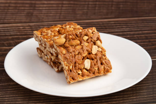 istock Peanut Candy Bars Mithai Or Giurgiulena Known As Meetha Chikki, Gud Patti, Gur Mungfali Chiki, Gajak, Tilgul, Gajjak, Gazak Or Gachak Is Made Of Moongfali And Jaggery. Makar Sankranti And Lohri Food 1358184591