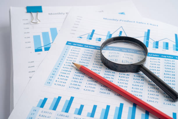 istock Magnifying glass on charts graphs paper. Financial development, Banking Account, Statistics, Investment Analytic research data economy, Stock exchange trading, Business office company meeting concept. 1358184639