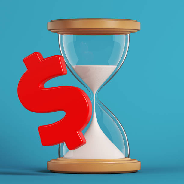 istock Red-colored Dollar symbol and hourglass. 1358185387
