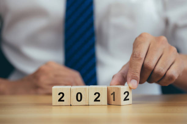 istock Businessman hand turning cube from 2021 to 2022 1358189327