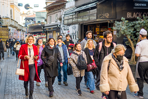 Istanbul, Turkey - December 02, 2021: Besiktas, Besiktas Fish Bazaar to Istanbul, Turkey. People walking on Besiktas Street in Istanbul