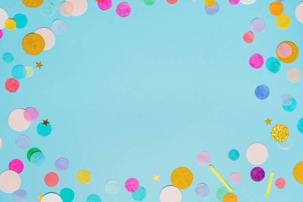 istock Frame of multicolored confetti on blue background with blank space for text 1358191198