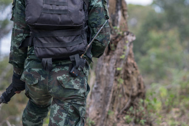istock close up soldiers with gun. 1358192088