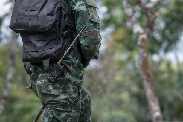 istock close up soldiers with gun. 1358192098