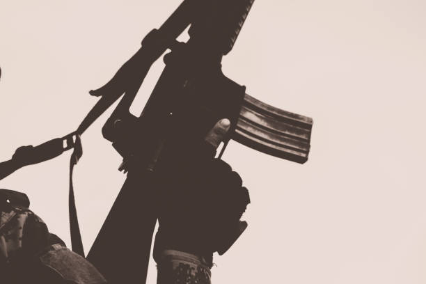 istock close up soldiers with gun. 1358192121