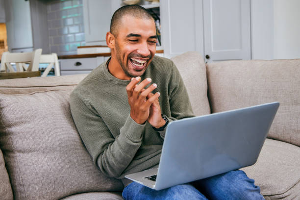 istock Shot of a young man using his laptop to work from home 1358192349