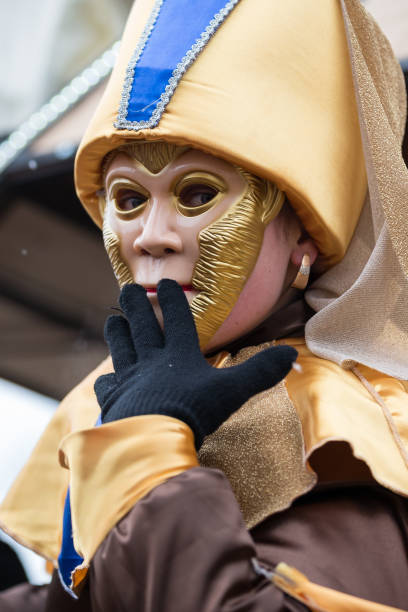 Burano, Venice, Italy - February, 18, 2020: Traditional Venice Carnival in Venice, Italy. People wearing masks and colorful costumes at the carnival