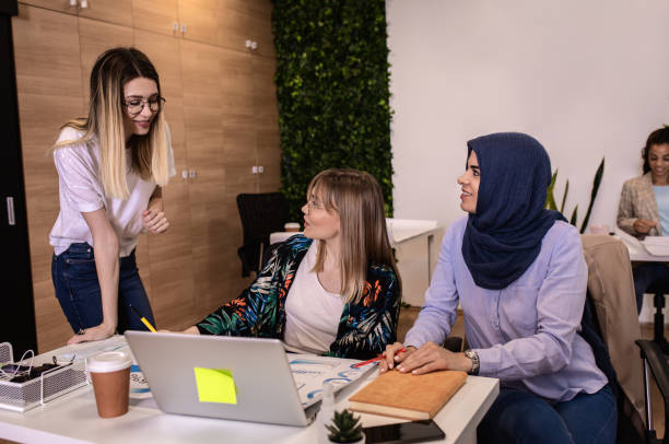 istock Group of a young multiracial woman working in office. 1358194206