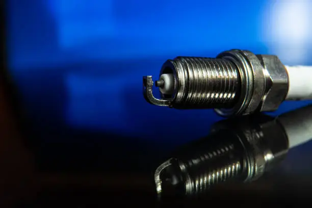 macrophoto of spark plugs on a blue background