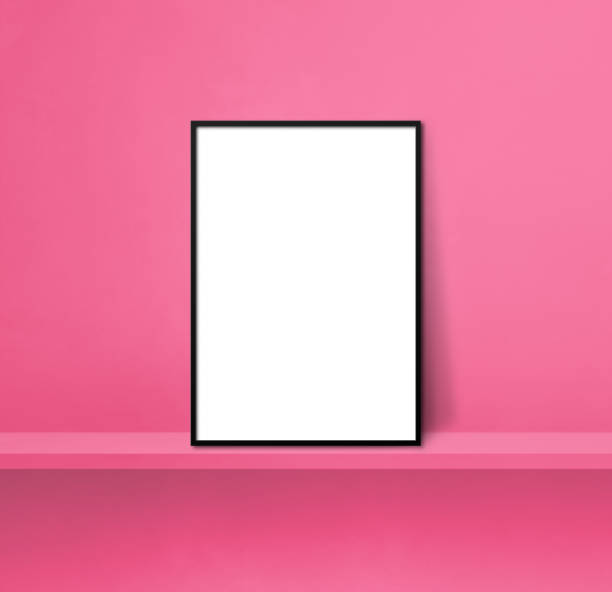 istock Black picture frame leaning on a pink shelf. 3d illustration. Square background 1358194645