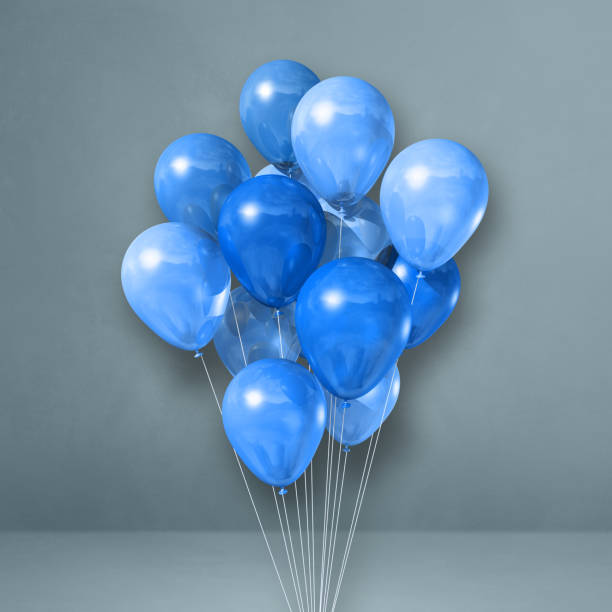 istock Blue balloons bunch on a grey wall background 1358195162