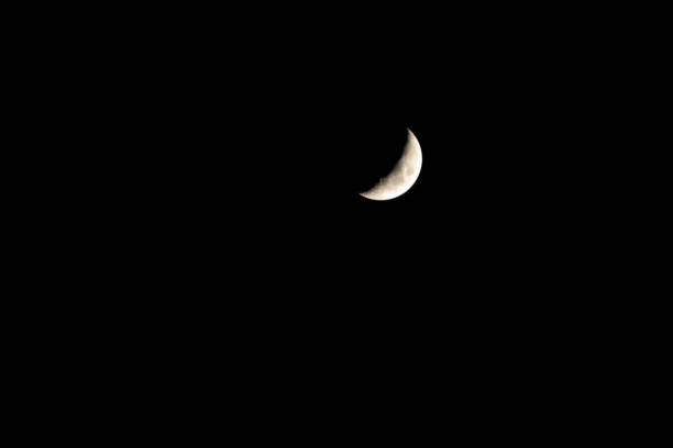 istock Crescent moon shining in the night sky 1358195492