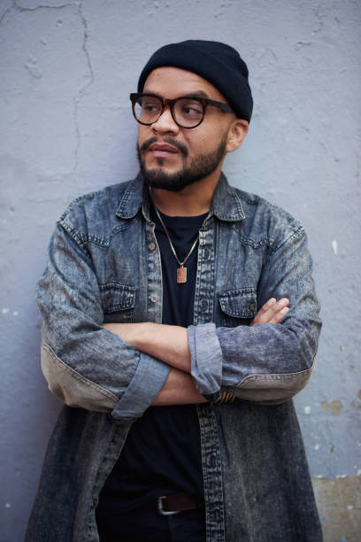 istock Cropped shot of a handsome and stylish young man looking thoughtful while posing outside against a grey wall 1358196421
