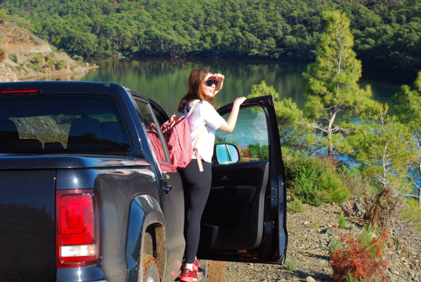 istock Woman looking at view from off road car 1358197445