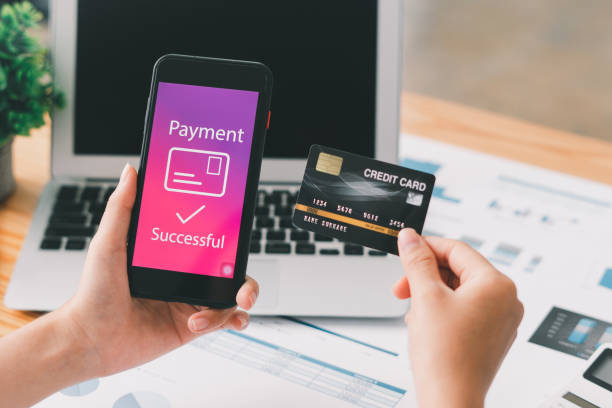 istock Hands holding credit card and using smartphone. Online shopping concept. 1358198506