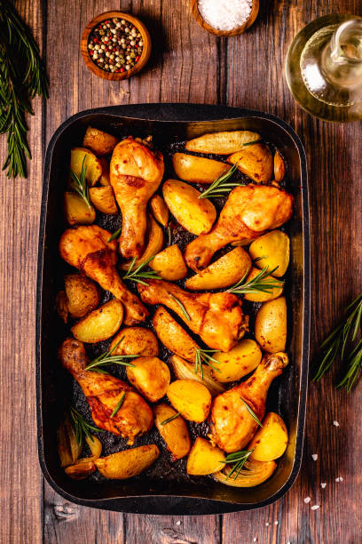 istock Roasted chicken legs with potatoes and rosemary. 1358198914