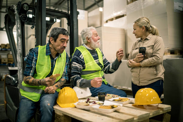 istock Warehouse worker relaxing and eating lunch 1358199713