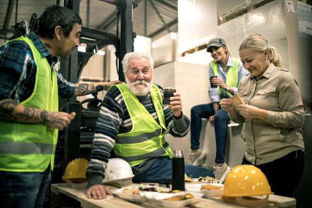 istock Warehouse worker relaxing and eating lunch 1358199714