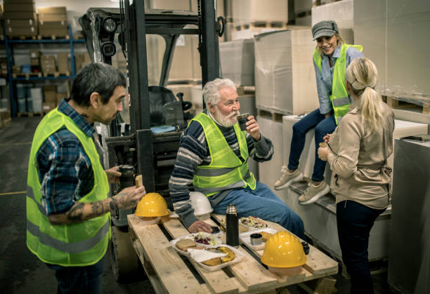 istock Warehouse worker relaxing and eating lunch 1358199717