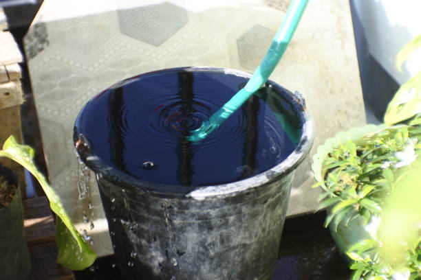istock water spills from black bucket. full does not fit anymore. overload 1358199841