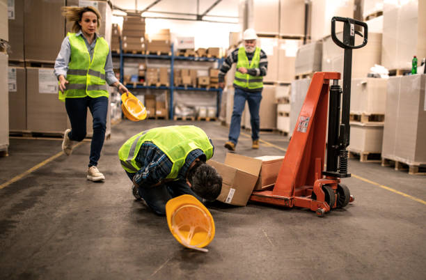 Warehouse worker after an accident in a warehouse Warehouse worker after an accident in a warehouse misfortune stock pictures, royalty-free photos & images