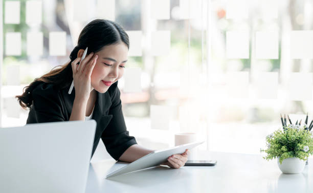 istock Young businesswoman working on portable tablet at office. 1358201062