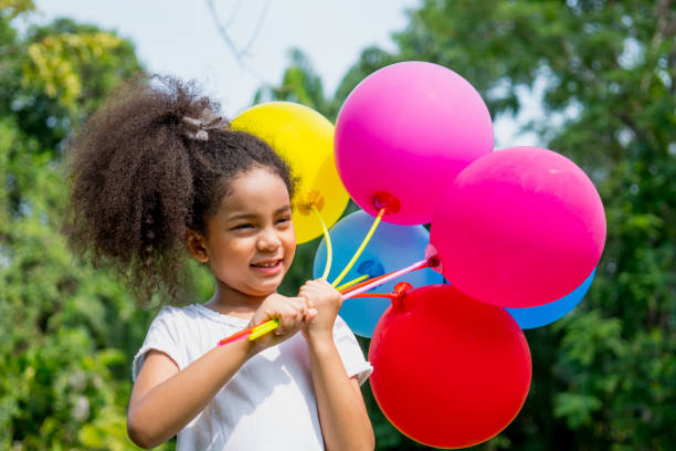 little girl with balloons relax in weekend holiday lifestyle park outdoor nature background. - personal accessory balloon beauty birthday imagens e fotografias de stock