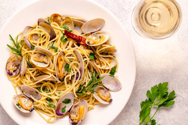 Seafood pasta with clams Spaghetti alle Vongole on a light background. Top view stock photo
