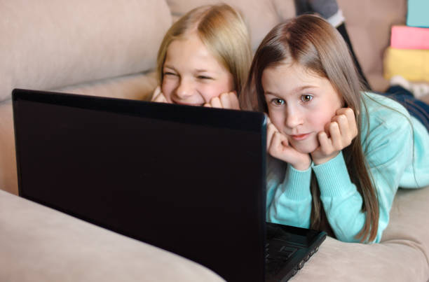 istock Two girls communicate on a laptop 1358204724