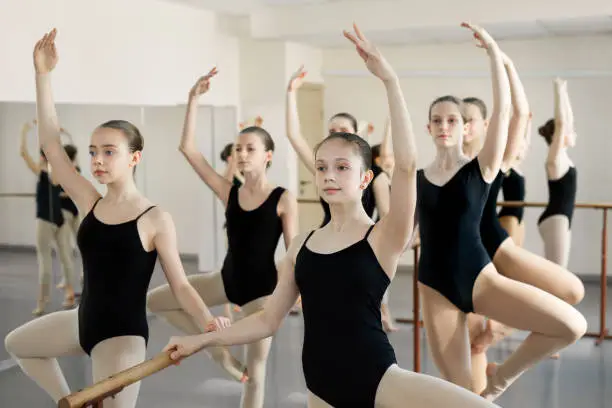 Young students ballerinas in choreography class of ballet school