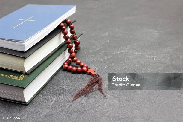 Books And Rosary On Black Cross On Cover Of Top Book Stock Photo - Download Image Now