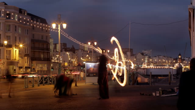 BUSY SEAFRONT FIRE JUGGLING NIGHT TIME