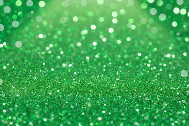 istock Green bright glitter bokeh background. 1358214379