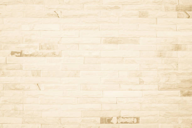 istock Empty background of wide cream brick wall texture. Beige old brown brick wall concrete or stone textured, wallpaper limestone abstract flooring/Grid uneven interior rock. Home decor design backdrop. 1358216813
