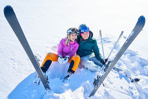 Young couple having fun while winter skiing. High quality photo