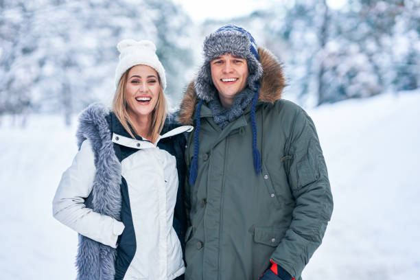 istock Couple having fun in winter scenery and snow 1358217945