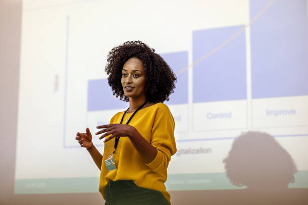 Woman entrepreneur at seminar giving presentation Woman entrepreneur speaking in the auditorium at the corporate training event. Woman at seminar giving a presentation. conference event stock pictures, royalty-free photos & images