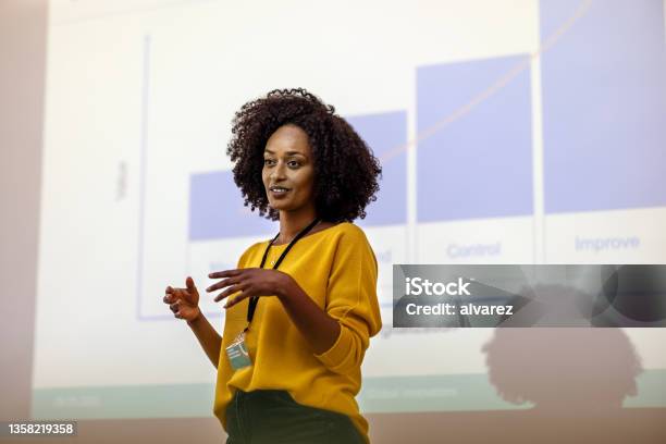 Woman Entrepreneur At Seminar Giving Presentation Stock Photo - Download Image Now - Presentation - Speech, Public Speaker, Data