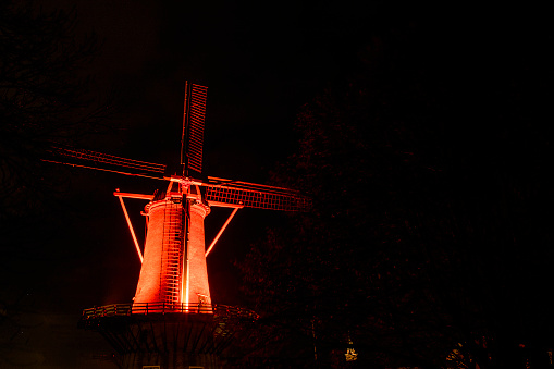 Windmill in Hellevoetsluis. Hellevoetsluis, South Holland, Netherlands, lit orange in December to draw attention to violence against women