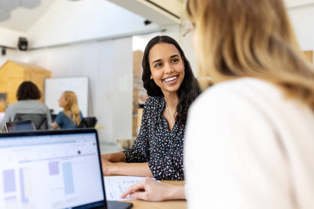 istock Two smiling businesswomen working together at startup office 1358219454