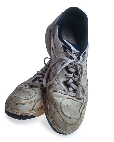 Old leather boots at  cement floor background texture. Old shabby boot shoes