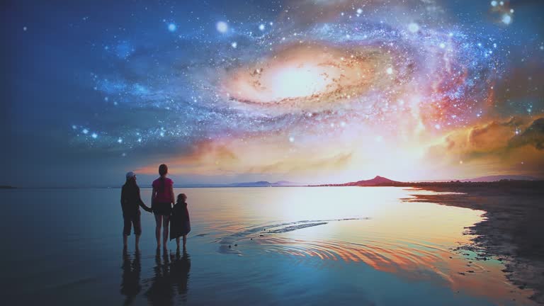 Children holding hands looking at the universe on some distant alien planet shore. Beautiful cinematic scene. Symbol or hope, imagination, future.