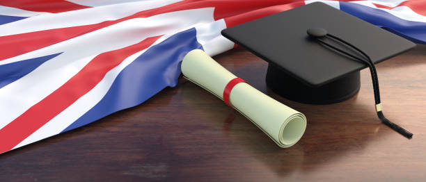 UK education and studies. College, university diploma roll on wooden office desk. 3d illustration stock photo