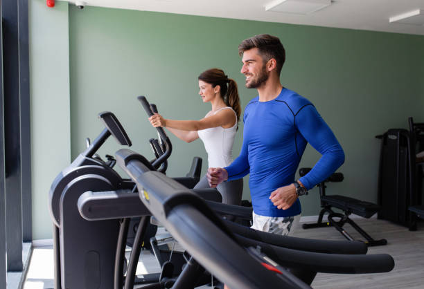 istock Smiling couple exercising at home gym. 1358220004