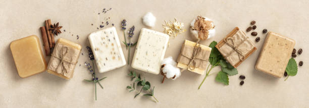 Natural soap bars and ingredients on beige background, flat lay