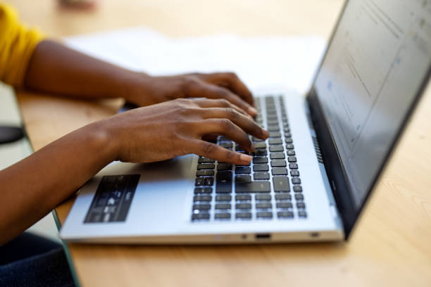 istock Close-up of businesswoman's hands using laptop 1358222268