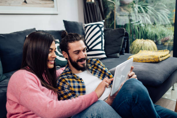 istock Happy couple shopping online on a tablet 1358222332