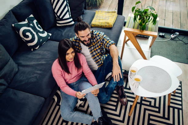 istock Happy couple shopping online on a tablet 1358222344