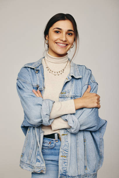 istock Stylish young woman smiling at the camera in a studio 1358222660
